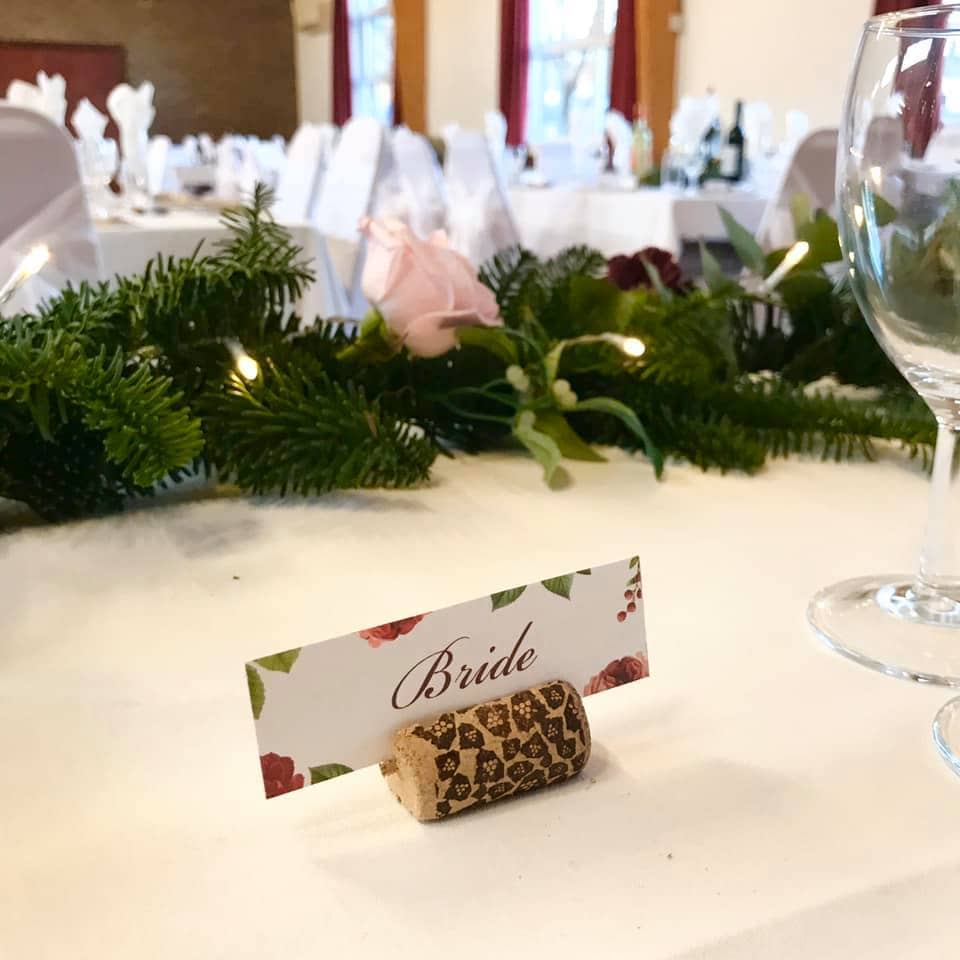 Floral flat place card presented in a cork stand